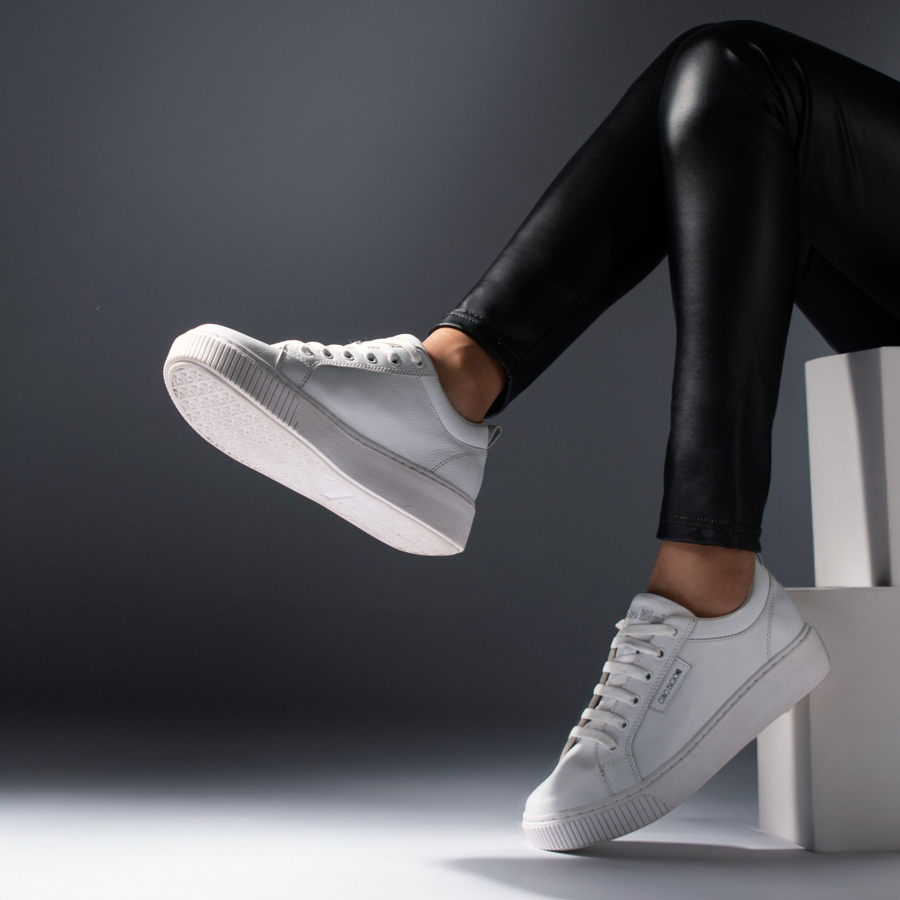 Minimal white sneakers in a modern studio setting